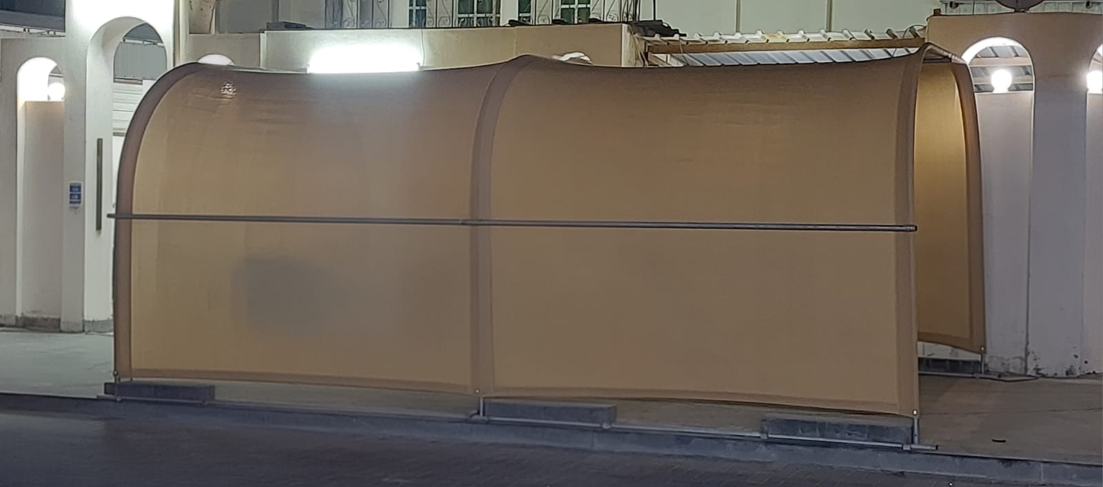 Closed beige shade structure at night